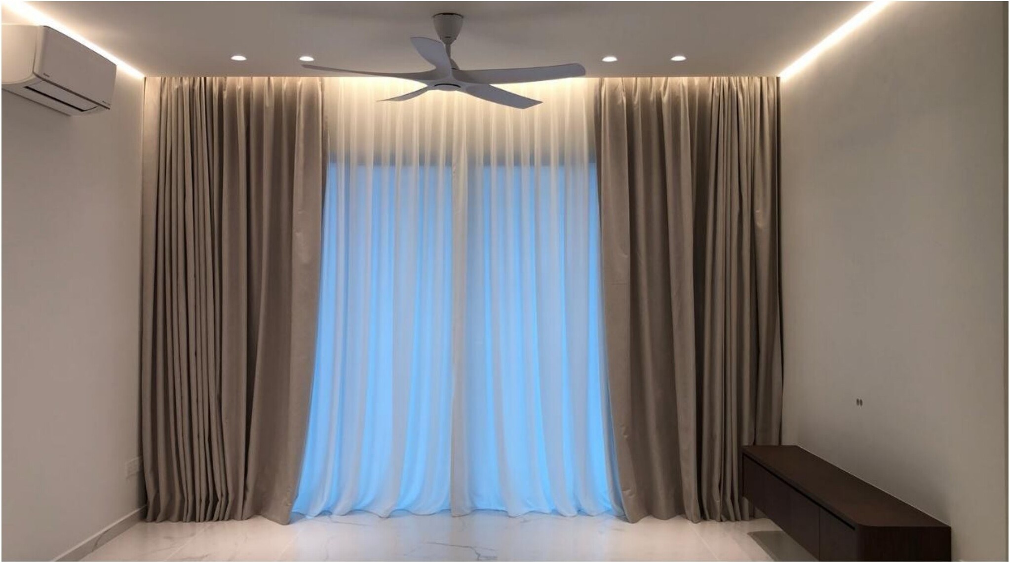 Day-and-night curtains in modern condo living room with ceiling fan