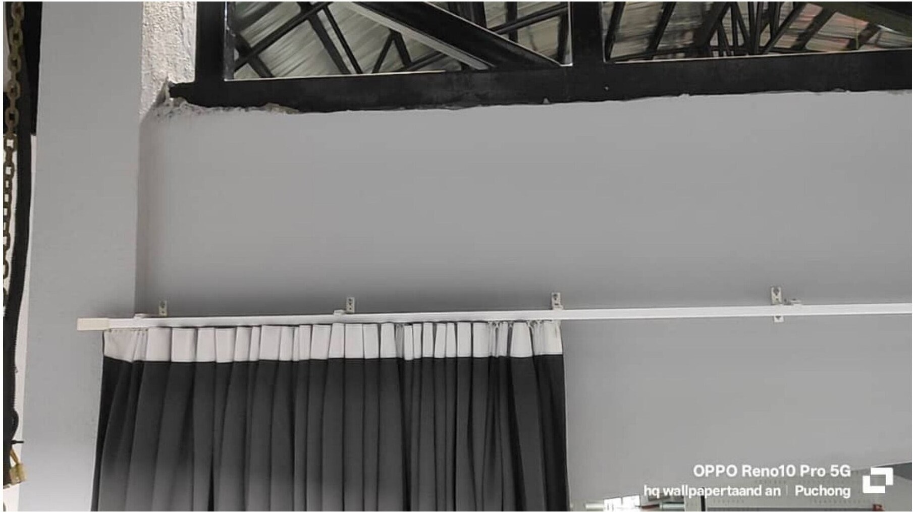 Two-tone pleated curtains on industrial ceiling track