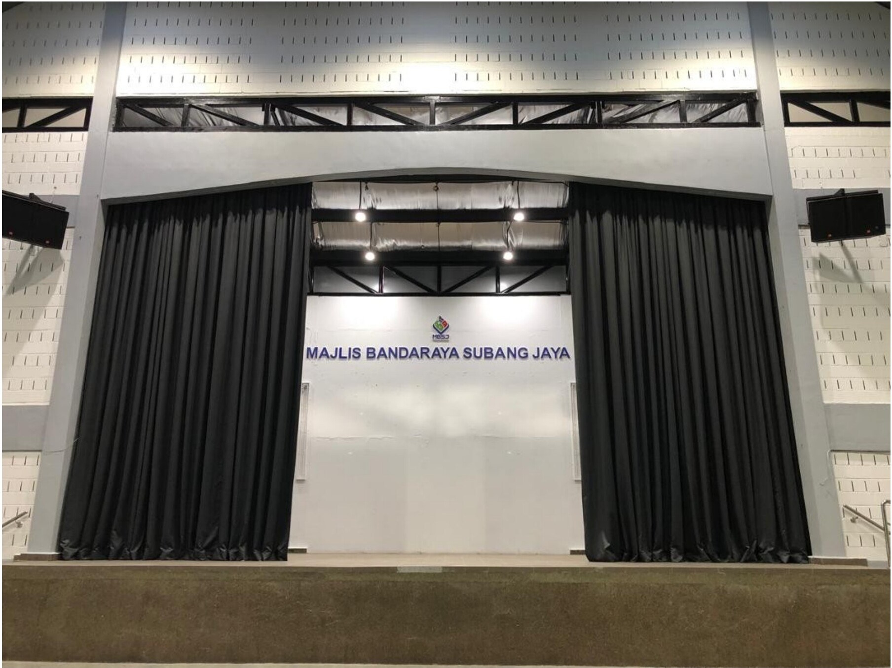 Black stage curtains and PA system at Subang Jaya event hall