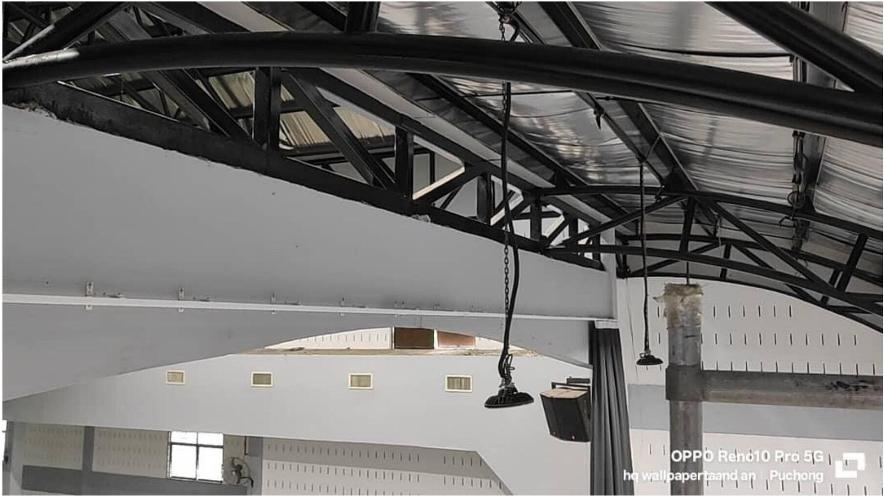 Hanging curtain installation work in industrial event hall