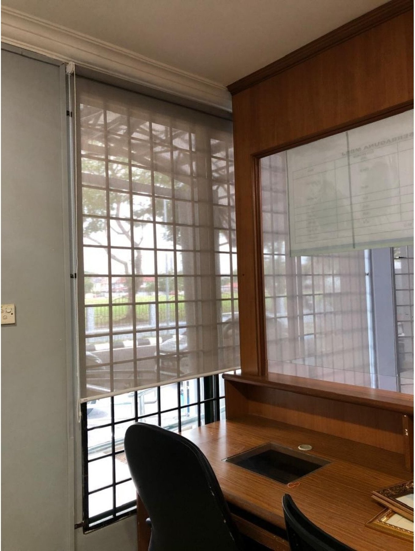Sunscreen roller blind in a Malaysian classroom with desk view