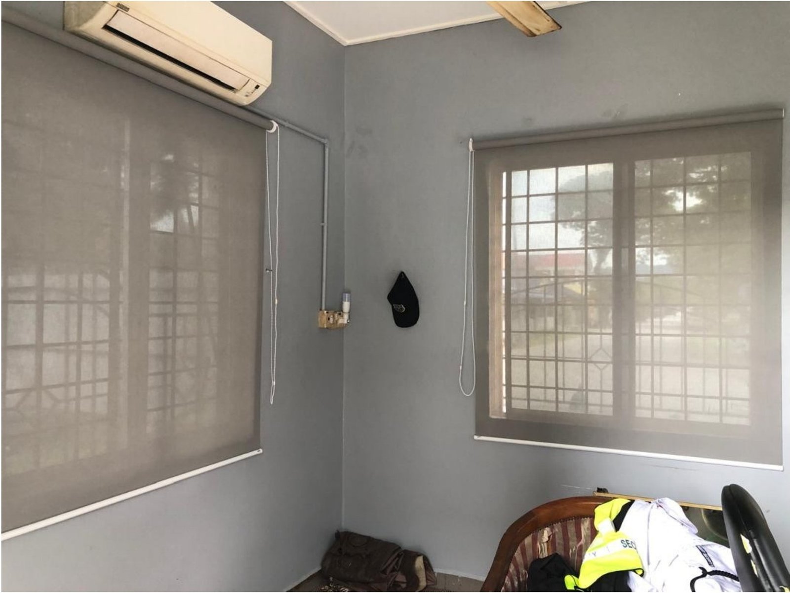 Two roller blinds in a Malaysian site office with aircon