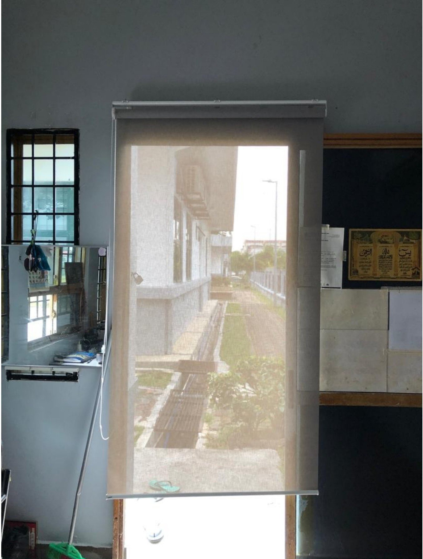 Sunscreen roller blind with view of school building, Selangor