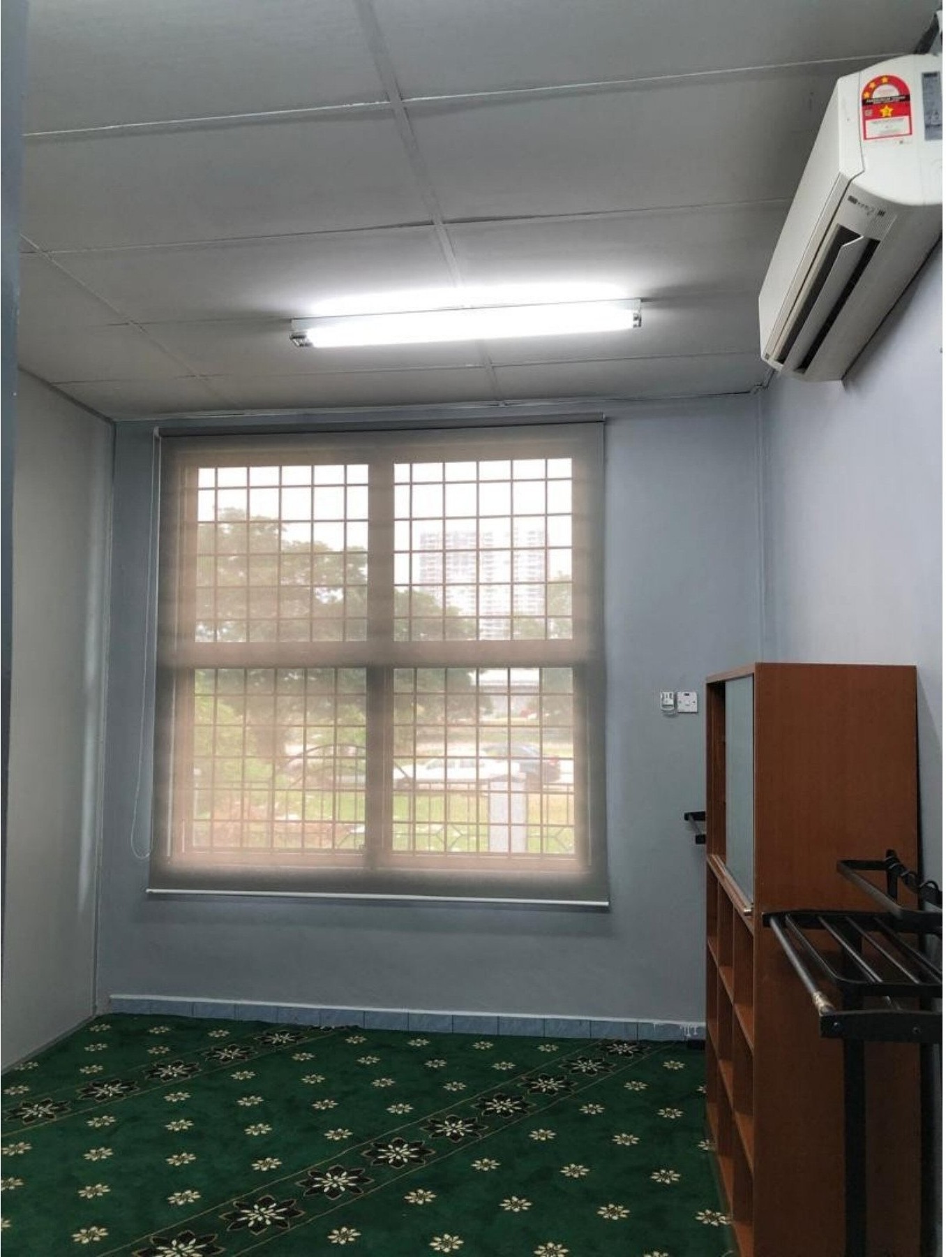Roller blind in a wood-panelled Malaysian office workstation