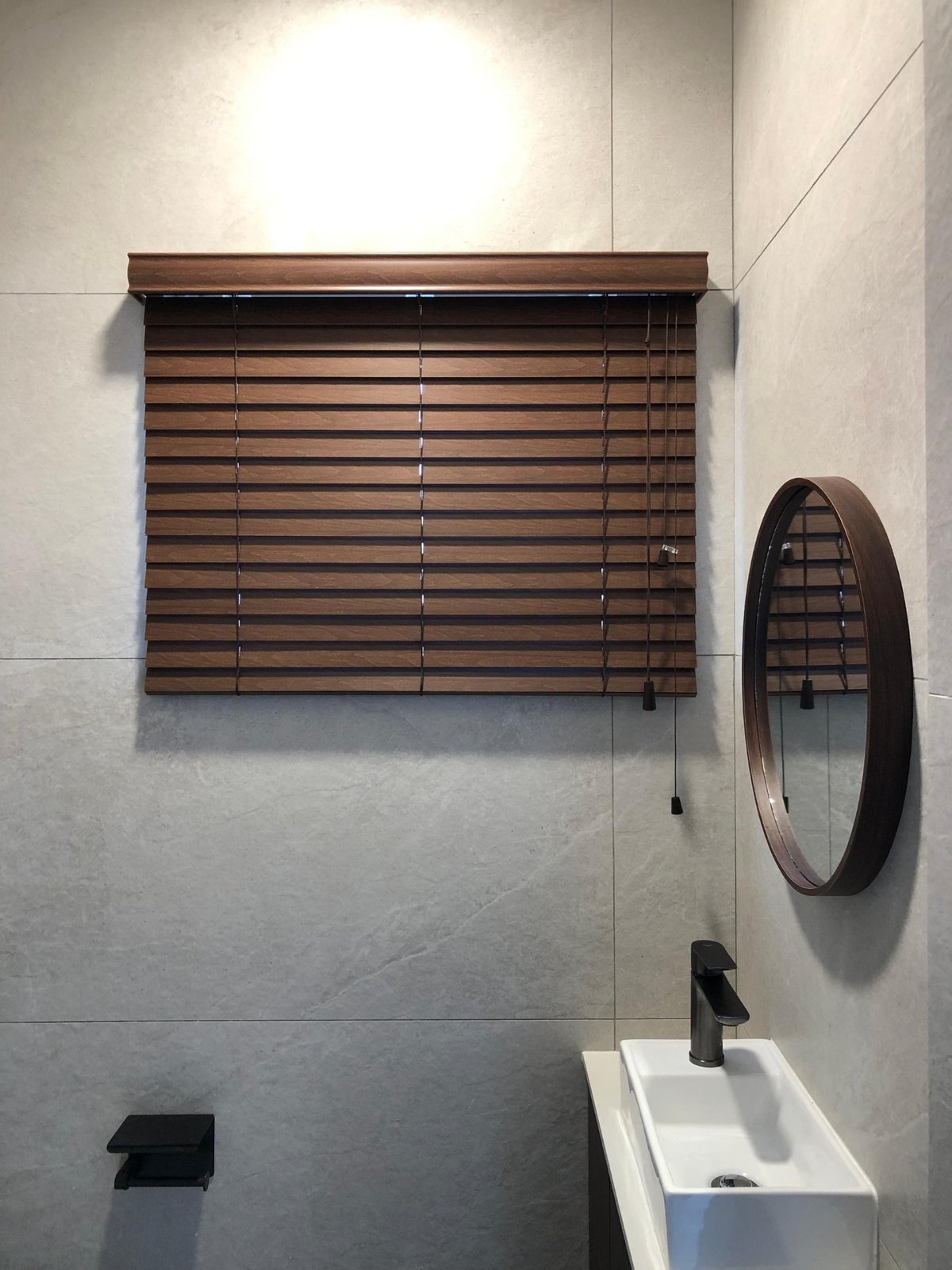 Walnut faux-wood venetian blinds in a modern Malaysian powder room