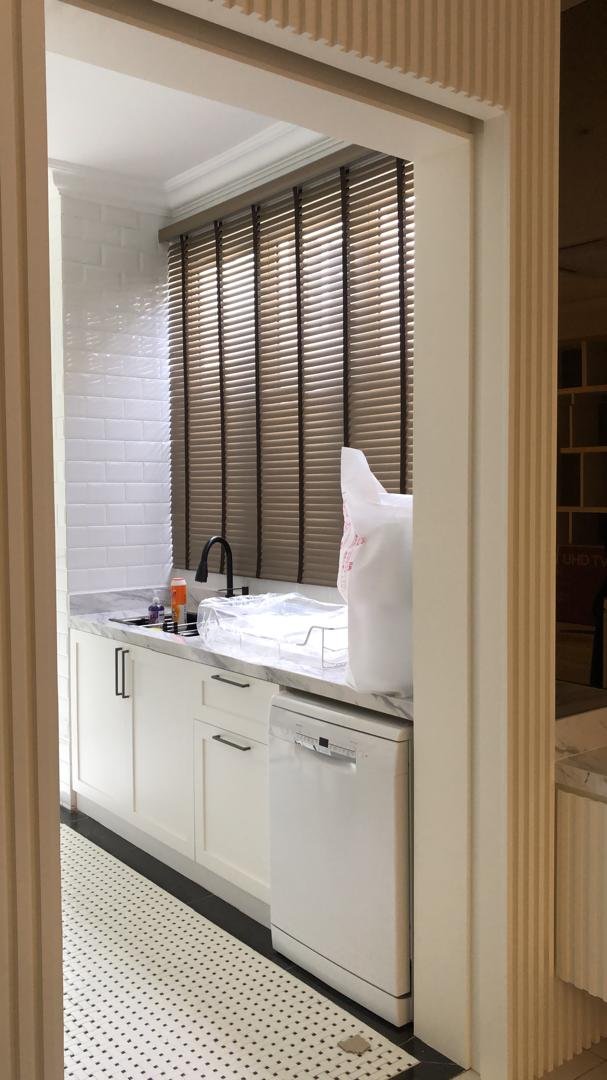 Bronze venetian blinds in a Malaysian wet kitchen seen from doorway